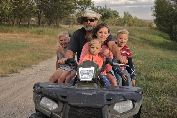 Delwin with Kids on Quad