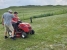 Del teaches Hayden how to run a riding lawn mower