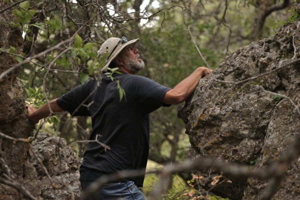 Delwin climbs a rock